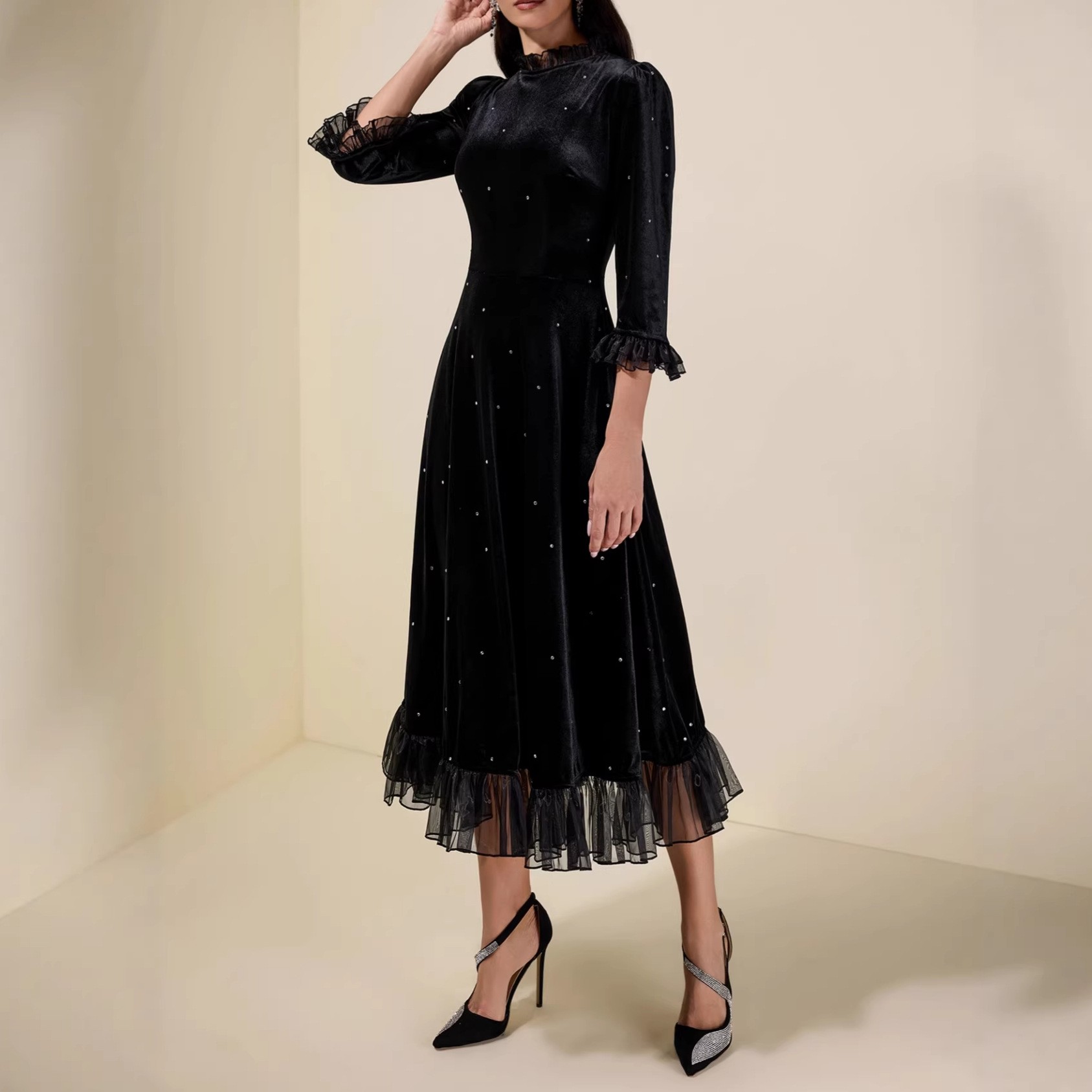 Black sequined chiffon halter-neck dress with three-quarter sleeves and frilled edges