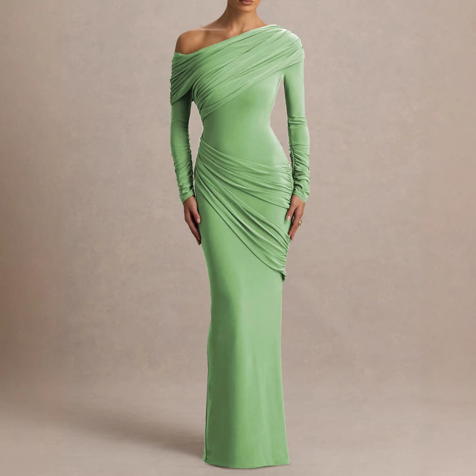 A pleated and frilled elegant light green full-skirted dress with a slanted neckline