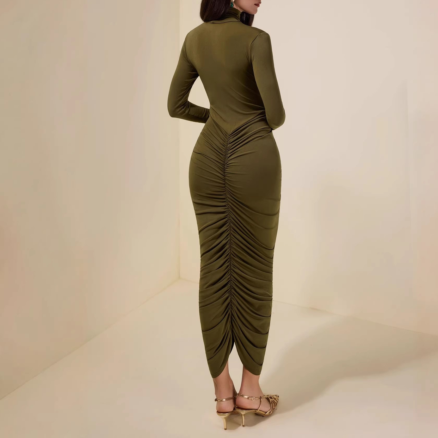 High-neck long-sleeved green pleated midriff-baring women's dress with a fitted waist and full skirt