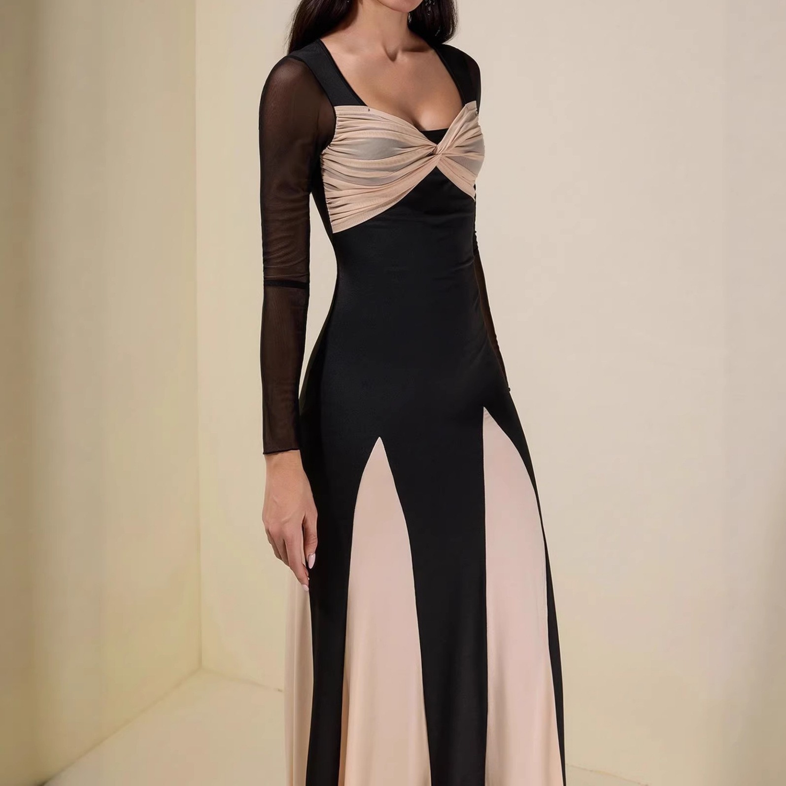 A long-sleeved women's dress with a fitted and elegant design, featuring a seamless and colorful blend