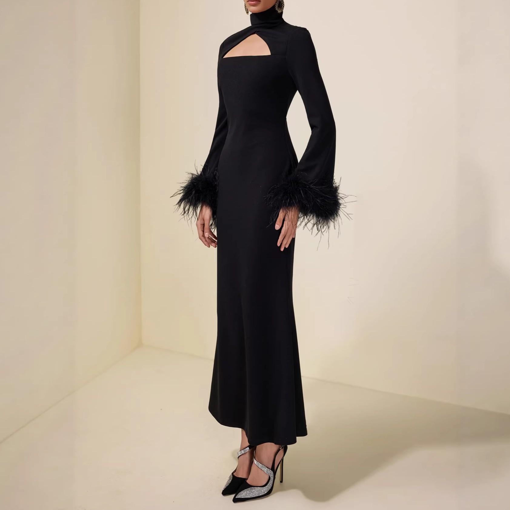 High-necked, fitted bodice, feathered cuffs, pure black, full-skirted, long dress with a flattering silhouette